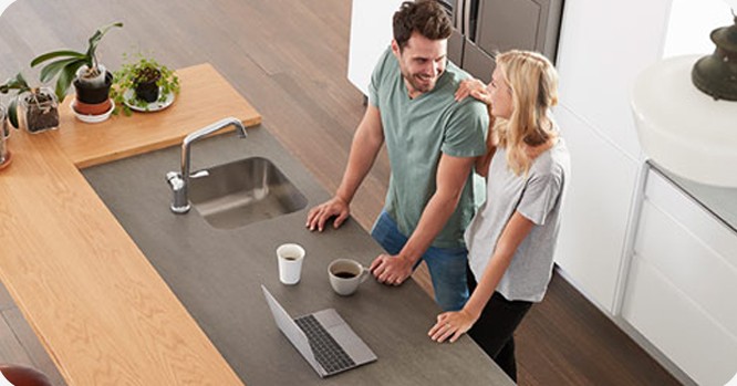 Couple smiling in their kitchen